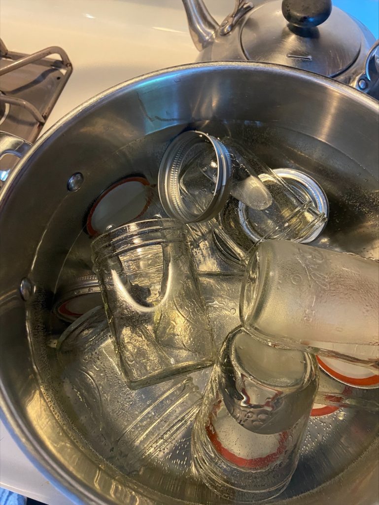 Sanitizing the jars by boiling them in water
